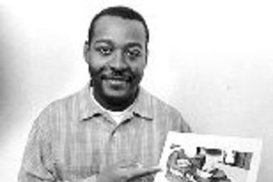Ronald Demon shows a picture of the frame of the "smart shoe" he developed and patented. Computer chips would be attached to the frame and then a leather or canvas covering would be added to finish the shoe in the desired style.