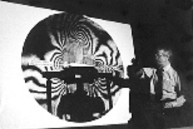 President Charles M. Vest shares some of his expertise in holographic interferometry as the "mystery guest lecturer" in Professor Stephen Benton's class on holographic imaging.
