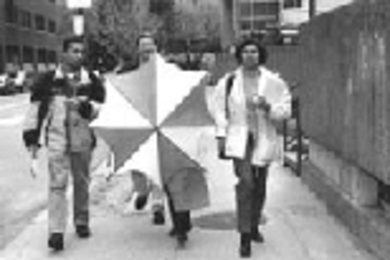 Team Delta makes its way toward second place in the Sloan Challenge fundraising competition. Left to right: MBA students Amit Jain, Craig Banaszewski and Anupama Bhave; Gwendolyn Hasse is behind the umbrella.