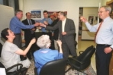 Toasting the new Vitesse chair are (seated, left to right) Carmenza Fonstad, wife of Professor Clifton Fonstad, first holder of the chair, and his mother, Grace Fonstad. Standing, left to right: Professor Fonstad; Louis Tomasetta of Vitesse; Professor Fonstad's son Nils, a Sloan School graduate student; son Diego Fonstad (partially hidden); Alex d'Arbeloff, chairman of the Corporation; and Profess...