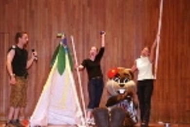 Students camp it up on stage during orientation.