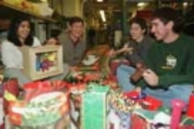 In Professor Steven Leeb's freshman seminar, students made toys that they gave out at a party last Saturday. Associate advisor Maya Chandru (left), a sophomore in physics, creates figures for a puppet theater she designed. Freshmen Carlos Renjifo (second from right) plays with a top he made while freshman Evencio Rosales (right) cranks a handmade noise-maker as Professor Leeb looks on.