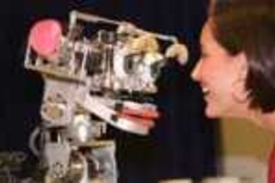 Dr. Cynthia Breazeal plays with Kismet, the robot that mimics and responds to human emotions.