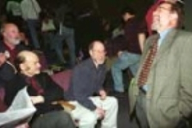 Nobelist David Baltimore (standing) a former MIT faculty member who is now president of Caltech, shares a laugh with biology faculty members (left to right) Richard O. Hynes, director of the Center for Cancer Research; Alexander Rich; and H. Robert Horvitz. Dr. Baltimore was on campus to give the Howard Hughes Lecture in biology.