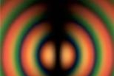 Rings of color generated by a computer simulate interference fringes observed in an experiment with light.