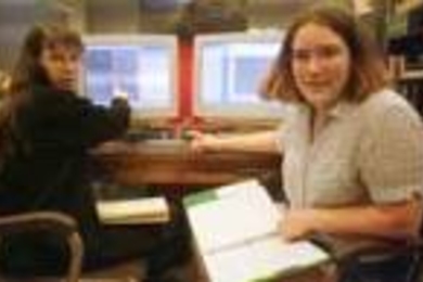 Graduate student Susan Kern (left) and Erica McEvoy, a sophomore in physics, discuss data obtained from the Magellan telescope.
