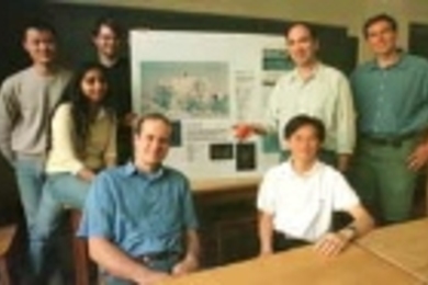 Professor Nicholas Makris (second from right, standing) holds an acoustic sensor that his lab is developing. His research group hopes the sensor will help scientists learn whether there is a liquid ocean under the ice of Jupiter's moon Europa. The group includes (left to right) Sunwoong Lee, Purnima Ratilal, Josh Wilson, Michele Zanolin and Yi-San Lai (both seated at table), and Aaron Thode