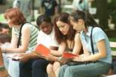 Left to right: Christine Fry, Shantel Poulson, Swati Saini and Tianlun Yu refer to the "Hitchhiker's Guide to Orientation 2001" while waiting for lunch in Killian Court.