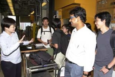 Professor of Chemical Engineering Jackie Ying gives a tour of her lab to students from the National University of Singapore.