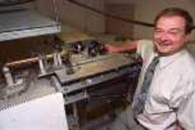 Paul Woskov shows off the Milliwave Viscometer, which won him his fifth R&amp;D 100 award.
