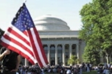 In the aftermath of the most memorable event of 2001, a student displays the American flag at a gathering of thousands of MIT communtiy members on Killian Court the day after the Sept. 11 terrorist attacks.