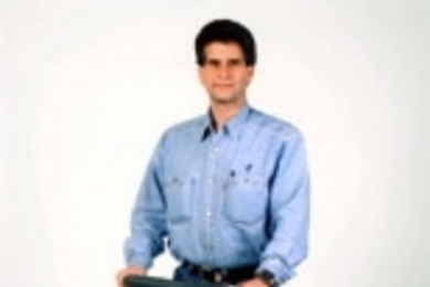 Inventor Dean Kamen, who won the Lemelson-MIT Program's $500,000 prize this year, stands on his latest creation, the Segway Human Transporter.