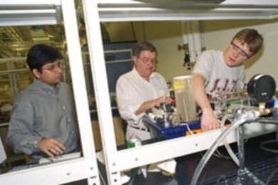 Left to right: Rubaiyat Amin Kahn, Professor Clark Colton and Richard West work with the heat exchanger in a chemical engineering lab. The machine can also be controlled remotely over the web.