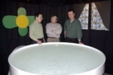 Research scientist Kazutoshi Nakazawa (left), Professor Susumu Tonegawa (center) and Professor Matthew Wilson stand next to the water tank where mice were tested for their memory of the location of a submerged platform.
