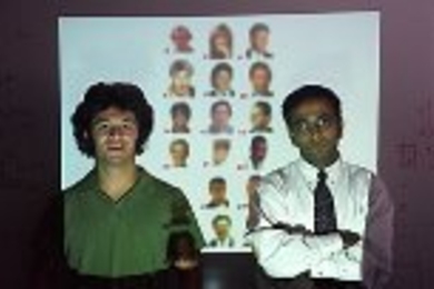 Graduate student Andrew Yip (left) and Assistant Professor Pawan Sinha stand before a screen showing blurred faces of celebritiesï¿½ï¿½ï¿½ï¿½ï¿½ï¿½ï¿½ï¿½ï¿½images used in their experiment on facial recognition. Click here to try the recognition test yourself and find out the identities of the celebrities.