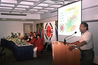 Dean Isaac Colbert addresses the Clinton Fellows in an Aug. 8 ceremony that marked the end of their nine-week stay at MIT. The 12 professionals from South Africa spent the summer on campus and traveling in the United States to learn more about the role of non-governmental organizations in a democratic society.
