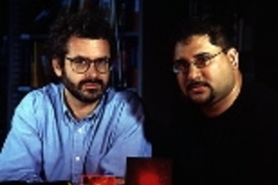 Professor Neil Gershenfeld (left) and alumnus Ravi Pappu with an epoxy token made of tiny glass spheres that may improve digital information security on the Internet and elsewhere.