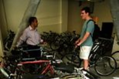 Graduate students Sham Sokka (left) and Chris Cassa chat in the bike room at the new graduate dorm at 70 Pacific St. Students can rent bikes for $1 a day or store their own bikes there.
