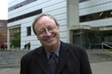 William J. Mitchell poses in front of the Media Laboratory.