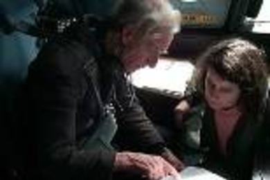 Professor Reginald Newell and Priscilla Burrow of the U.S. Naval Academy discuss a weather image during a flight on a P-3B aircraft.
