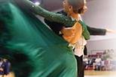 Former MIT Ballroom Dance Team members Reena Freedman and Michael Posner (hidden) show off their winning whirl in the MIT Open Ballroom Dance Competition.