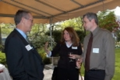 Associate Professor Roger Petersen of political science and his wife, Daniella Stojanovic, chat with President Charles M. Vest at the Gray House reception for 16 professors granted tenure by the Executive Committee of the MIT Corporation.
