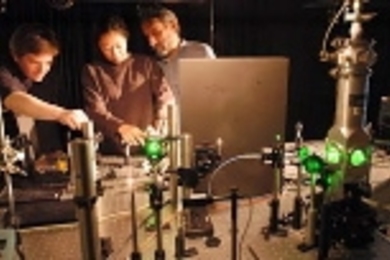 Postdoctoral associate Preston Snee, graduate student Aetna Wun, and Professor of Chemistry Daniel G. Nocera (left to right) use a laser microsensor.