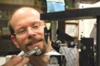 Professor Michael Yaffe loads a tiny protein crystal onto an X-ray diffractometer machine to study its structure.