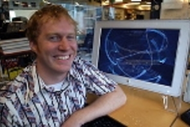 Graduate student Ben Fry with a computer screen showing "Valence," a visual representation of the algorithm (called BLAST) that's most commonly used for genome searches.