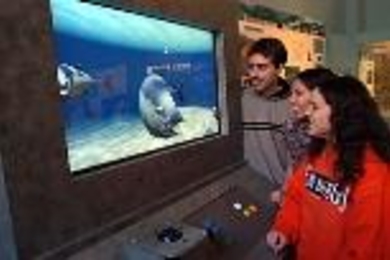 The creators of iQuarium, a virtual underwater environment that shows how fish swim, try out the interactive exhibit in the Hart Nautical Gallery. Left to right: Aaron Sokoloski, a junior in mechanical engineering; Audrey Roy, a senior in electrical engineering and computer science; and Katie Wasserman, a senior in ocean engineering.