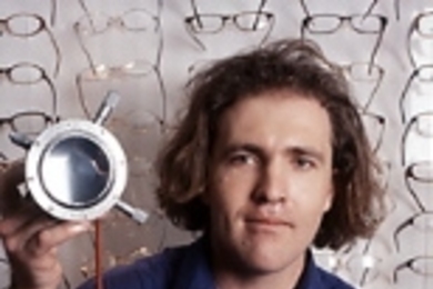Saul Griffith holds part of his lens molding device that can produce any eyeglass prescription lens quickly and inexpensively.