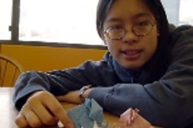 Sophomore Kathy Lin shows a pair of origami elephants she made.