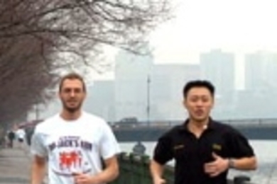 Triathletes Ken Ross, a computational biologist at the Broad Institute, left, and Harn Wei Kua, an MIT graduate student in architecture and mechanical engineering, train by the Charles River. Ken will run in the Boston Marathon on Monday, April 19.