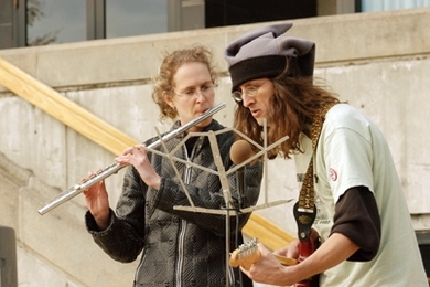 Guitarist Martin Hunter (right) and flutist Alison Hearn play at the rally organized by the MIT Free Radicals held at the Student Center.