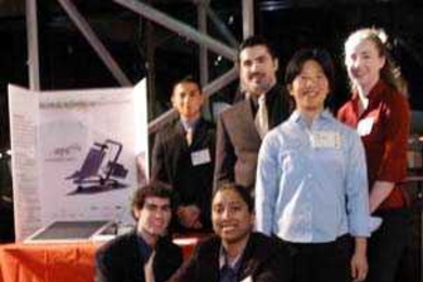 Smitha Raghunathan operates the Kinkajuice human-powered battery charger designed and built by her and her teammates, including (left to right) Etan Trangle, Jim Lin, Alfredo Bocanegra, Jennifer Hu and Lisa Chandler.