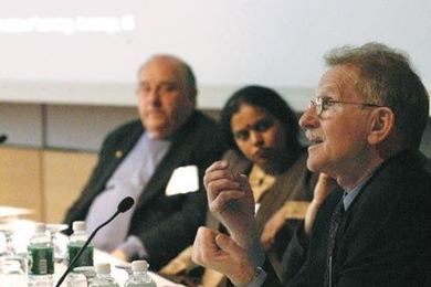 MIT Professor John Heywood, director of the Sloan Automotive Laboratory, far right, makes a point at the Alliance for Global Sustainability gathering on March 21 while panel members Leena Srivastava, executive director of The Energy and Resources Institute, India, and Professor David Marks, director of MIT's Laboratory for Energy and the Environment, look on.