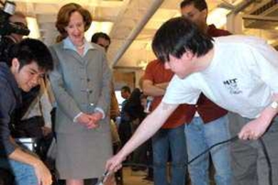 Graduate student Aaron Tan shows President Susan Hockfield how to direct a robot's movement with light during a May 5 presentation by the class Robotics Science and Systems I, organized in honor of Hockfield's inauguration.