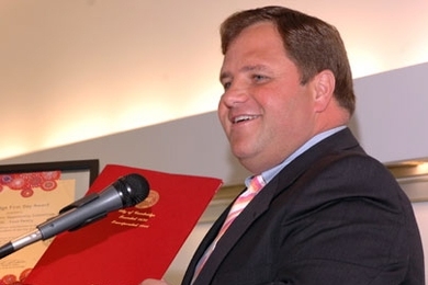 Cambridge Mayor Michael Sullivan praises the work done by Cambridge food pantries during the 13th annual Cambridge First Day celebration, held at MIT on June 7. He is holding one of the Cambridge First Day awards and a bound City Council resolution.
