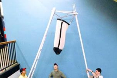 From left, Brian Shieh, James Labuz and Andrew Greenhut prepare their banana-harvesting device for a mockup review in 2.009.