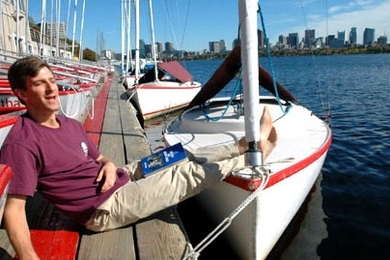 David Kessler, who works at MIT Sloan School of Management, breaks into song down at the Sailing Pavilion on Friday, Oct. 21. Kessler, who helped launch a series of sea chantey sings, is holding a book of sea chanteys.