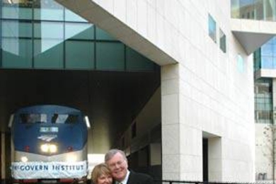 Lore Harp McGovern and Pat McGovern hug on the tracks that run under the brain and cognitive sciences complex, new home of the McGovern Institute for Brain Research at MIT. <a onclick="MM_openBrWindow('mcgovern-tracks-enlarged.html','','width=509, height=583')">
<span onmouseover="this.className='cursorChange';">Open image gallery</span>
</a>
<noscript> <a href="mcgovern-tracks-enlarged.html">...