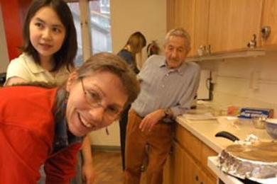 Associate Professor Anne McCants of history bastes the roast pork for her IAP session 'Old Food: Ancient and Medieval Cooking,' held Wednesday, Jan. 11, in the kitchen of Next House.