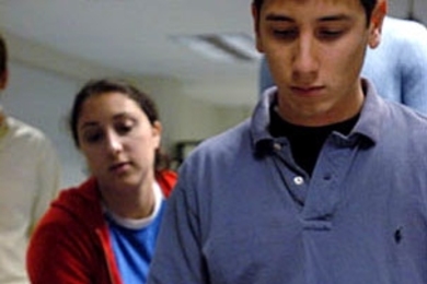 Senior Ira Simkhovitch helps move a model of an Easter Island head.