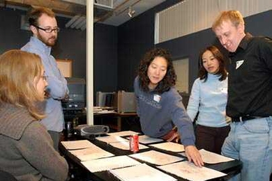 MBA students from the MIT Sloan School of Management work on a cartoon storyboard at the School of the Museum of Fine Arts on Tuesday, March 21, during Sloan Innovation Period. Pictured, from left, are Kielo Ahomaa, Tom Marquet (a Museum School student), Eun-Joung Lee, Lilly Zhu and Corey Halverson.