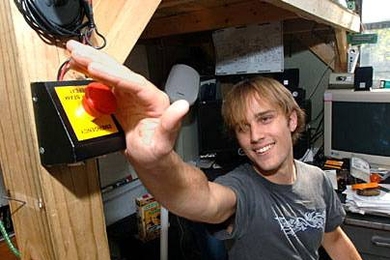 Freshman R.J. Ryan hits the 'emergency' button in his automatic dorm room on East Campus. The button activates 'party mode.'