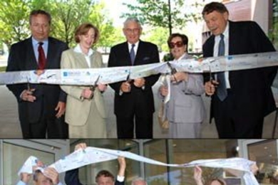 Cutting the ribbon at the Broad Institute opening on Tuesday, May 30, are, from left, Harvard President Lawrence H. Summers; MIT President Susan Hockfield; Eli and Edythe L. Broad, founders of the Broad Institute of MIT and Harvard; and Broad Institute Director Eric S. Lander. The same group celebrates the moment below.