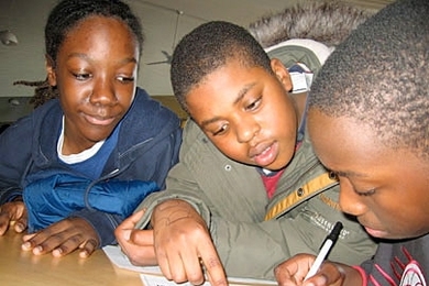 STEM students Terrain Edwards-Grant, Darren Chanel-Volmar and Jamie Edwards support one another's success.