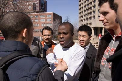 Edmund Aziabor MBA '07, center, negotiates with Saadiq Rodgers-King MBA '08, left, during a tense stand-off in "The Hunt," a new Sloan Innovation Period course.