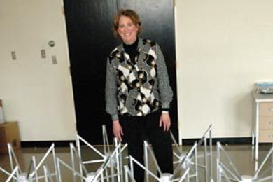 Physics professor Jacqueline Hewitt, director of MIT's Kavli Institute for Astrophysics and Space Science, stands behind a prototype of a radio telescope array. A team she leads has been chosen by NASA to develop plans for such an array on the far side of the moon.