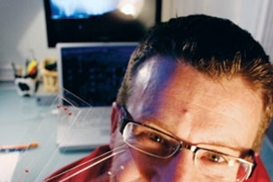 Roman Stocker, the Doherty Assistant Professor of Ocean Utilization, holds microfluidics devices.